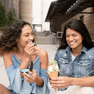 Invisalign Warner Center Cosmetic Dental Woman removing Invisalign to eat ice cream with friend